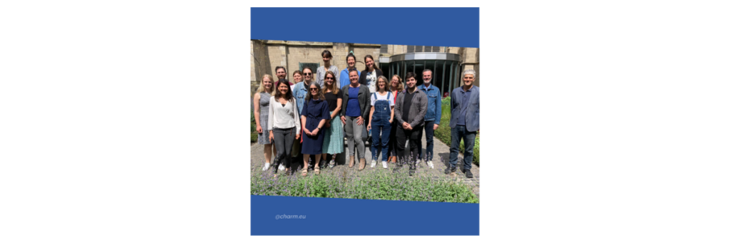 Group photo in a garden with an old building behind