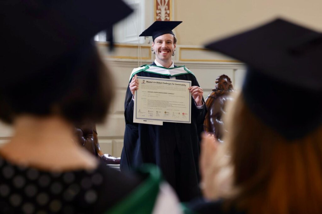 A graduate holds his degree during a graduation ceremony