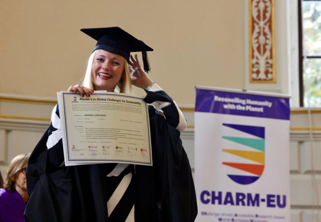 A graduate holds her degree