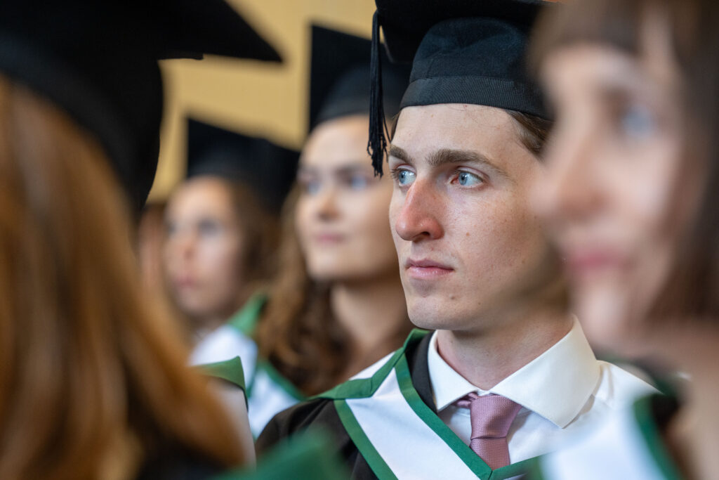 A graduate waits to receive his degree