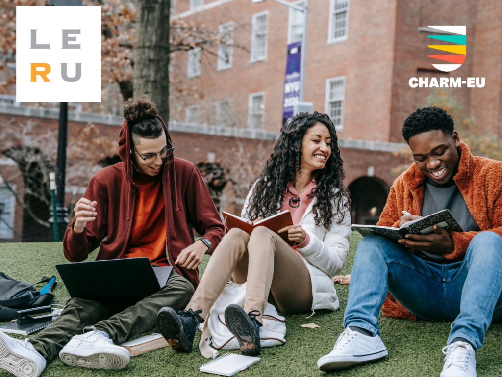 Photo: 3 university students, 2 boys and a girl, in the green grass of the university, with books in their hands smiling. Logos: LERU and CHARM-EU