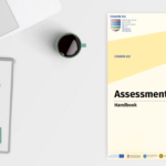 Picture of the laptop, booknote and coffee on a table together with the Assessment Handbook