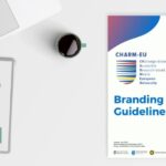 Picture of a laptop, a booknote and coffee on the table with the CHARM-EU Branding Guidelines.