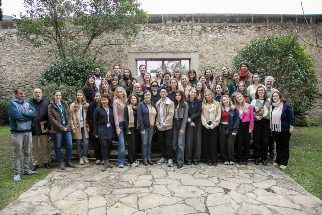 4th cohort of the CHARM-EU master's in global challenges for sustainability group photo in the gardens of the Faculty of Information, University of Barcelona. 40+ students pose for the group photo smiling and happy and relieved to have presented their capstone projects.