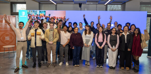 A large group of people celebrates and cheers together
