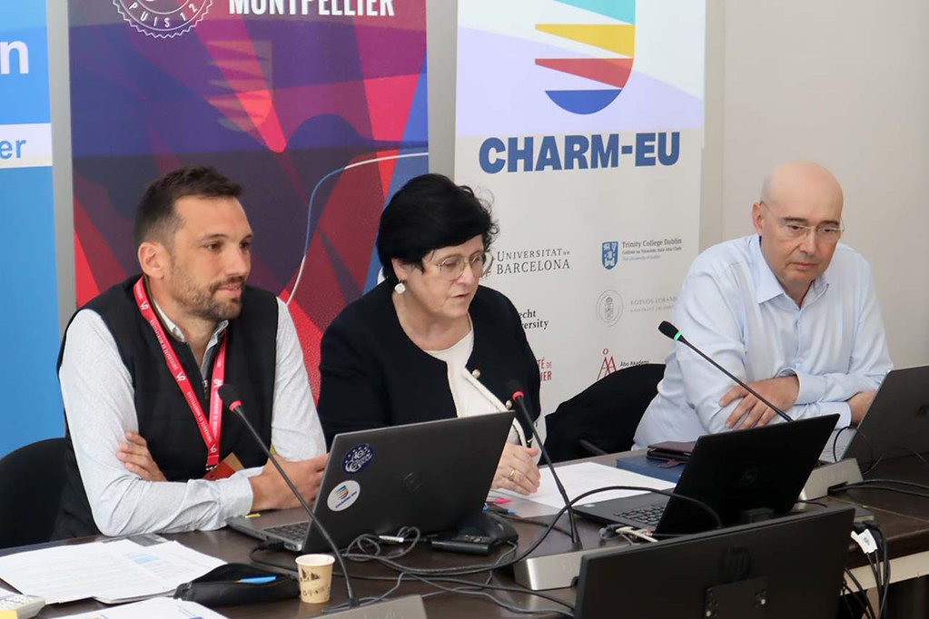 Panel discussion with speakers seated at a table in front of CHARM‑EU and Université de Montpellier banners.