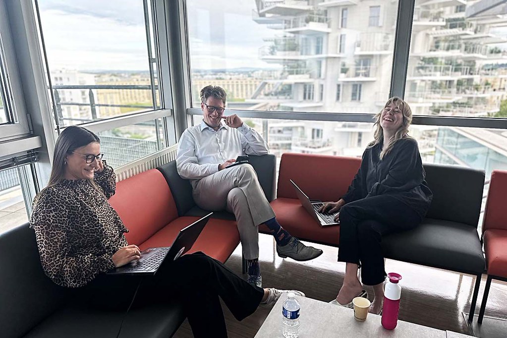 Participants working on laptops in a lounge area during a collaborative CHARM‑EU meeting.