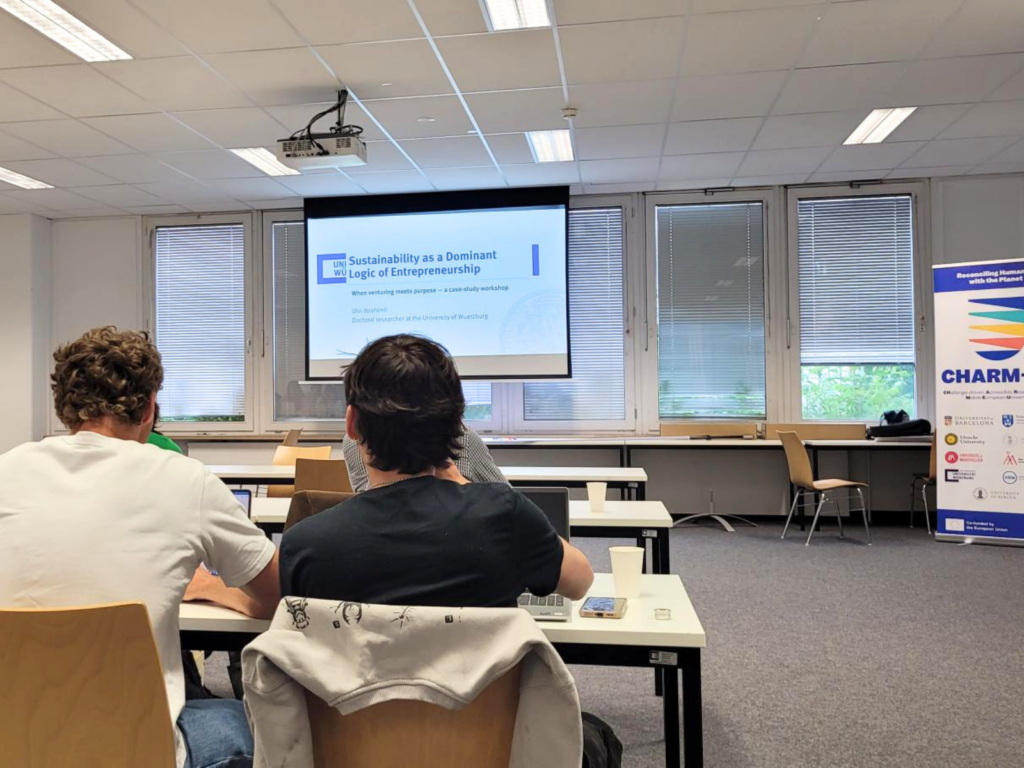 Participants seated in a classroom, listening to a presentation during a CHARM‑EU workshop.