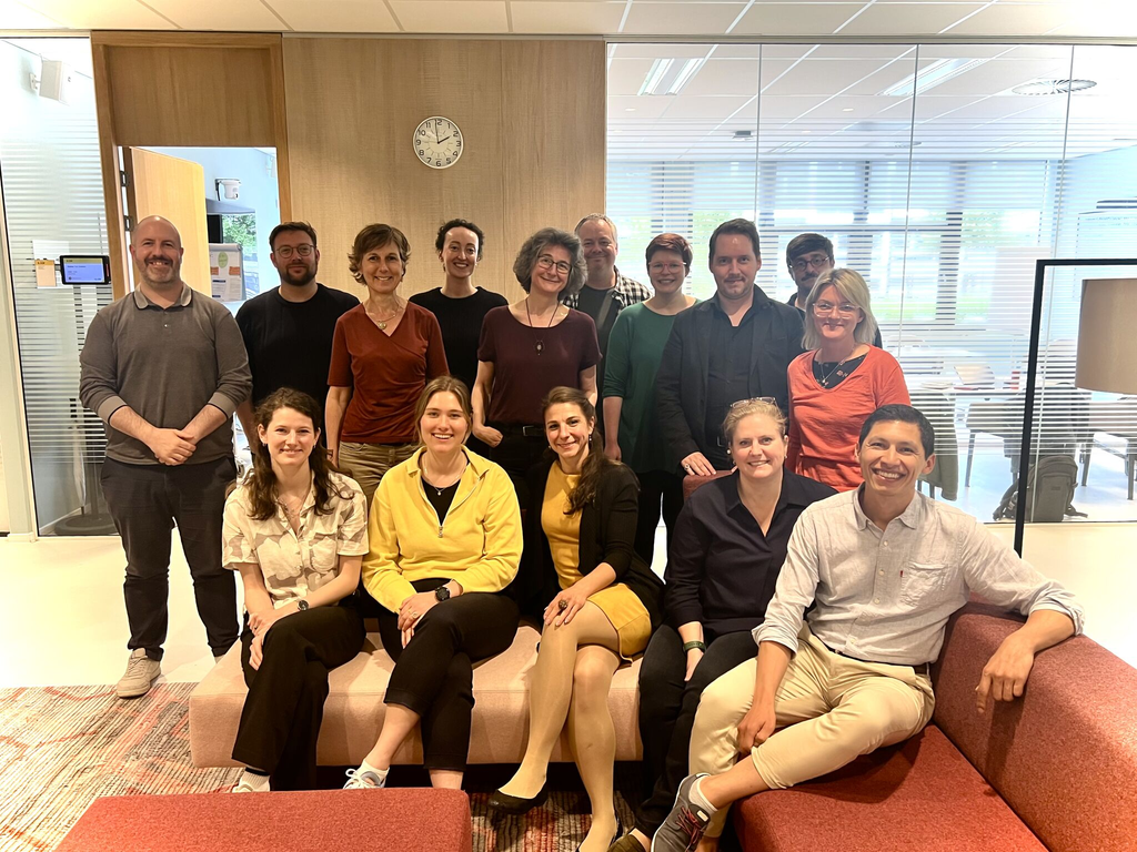 Group of participants posing together in a meeting room during a CHARM‑EU collaborative workshop or project meeting.