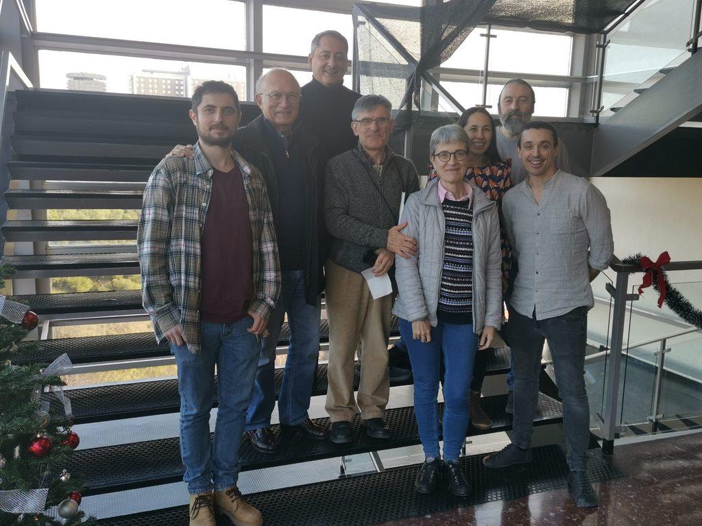 Group of participants posing on a staircase inside a university building during an international collaboration visit.