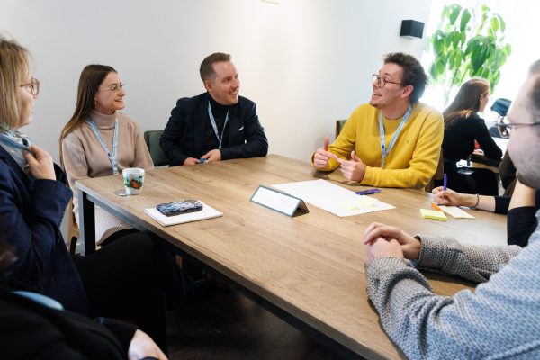 participants in discussion around a meeting table