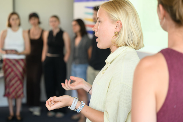 a photo of a student presenting to a small group.