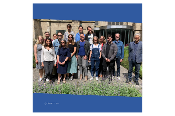 Group photo in a garden with an old building behind