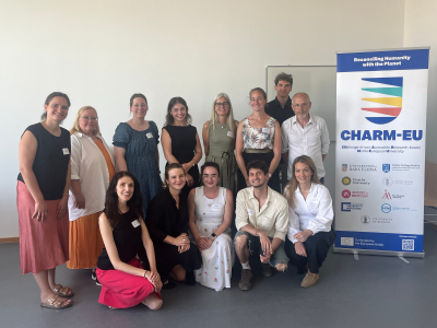 Group picture of the participants of the staff training next to the CHARM-EU roll-up.