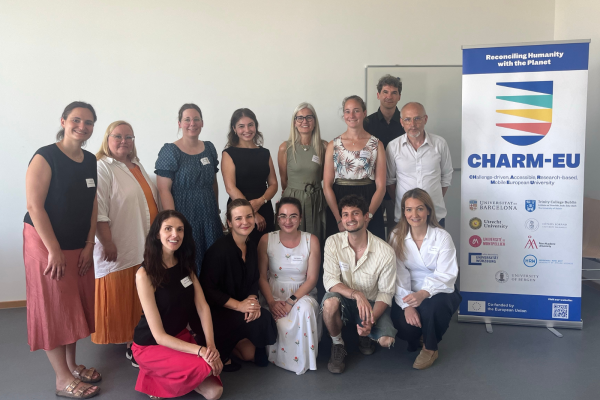 Group picture of the participants of the staff training next to the CHARM-EU roll-up.