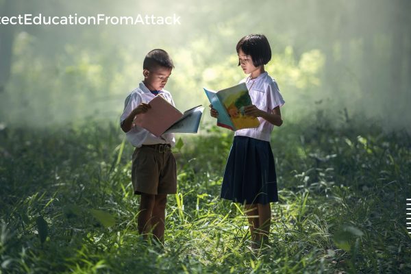 Two children reading a books in a forest