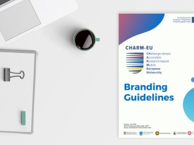 Picture of a laptop, a booknote and coffee on the table with the CHARM-EU Branding Guidelines.